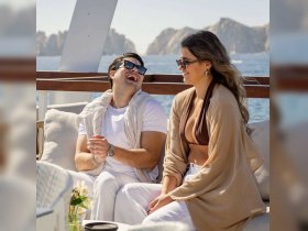 A joyful couple enjoys their time on a yacht, sharing laughter and creating unforgettable memories against a stunning ocean backdrop.