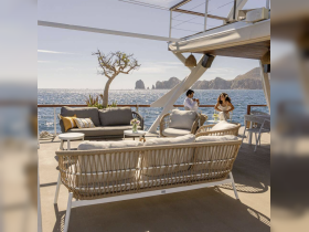 A stylish lounge area on a boat featuring comfortable seating and stunning ocean views, perfect for relaxing and enjoying the sea breeze.