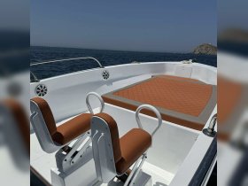 Interior view of a boat showcasing comfortable seating and a spacious deck area, perfect for relaxing while cruising on the water.