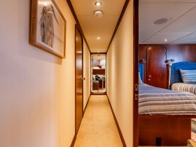 A well-appointed interior cabin of a boat, featuring cozy sleeping arrangements and elegant decor, perfect for relaxing during a voyage.