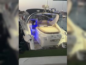 A stylish interior view of a luxury boat featuring comfortable seating and a well-equipped helm, perfect for relaxing and navigating the waters.