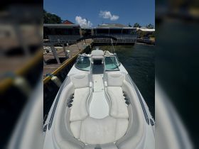 A spacious view of the interior seating area of a boat, showcasing comfortable lounge space ideal for relaxation on the water.