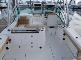 A clean and spacious interior view of a boat's helm and seating area, showcasing modern design and comfort for an enjoyable boating experience.