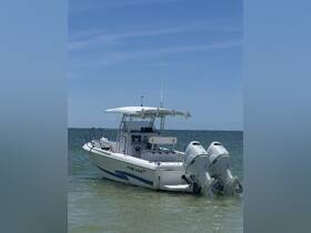 A sleek Pro-Line speedboat docked in shallow waters, showcasing its modern design and powerful twin engines — perfect for a day of adventure on the water.