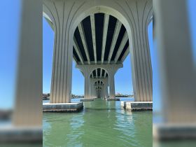 A view of a bridge structure over water, showcasing architectural details. The image lacks clarity and focus.