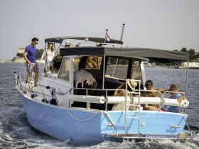 A lively group enjoys a day on the water aboard a boat, showcasing the perfect atmosphere for celebrations and fun with friends.
