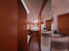 A cozy interior view of a boat cabin featuring comfortable seating and a well-equipped helm area, perfect for relaxing during your nautical adventures.
