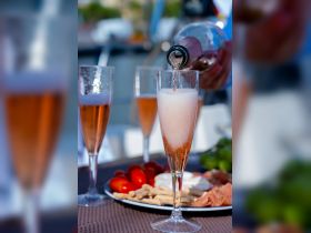 A beautifully arranged spread featuring cocktails and a charcuterie platter, perfect for enjoying a relaxing day on the water.