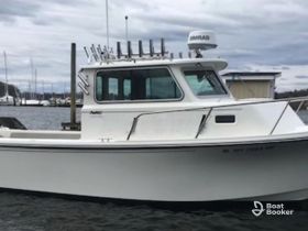 A clear side view of a well-equipped boat docked at the marina, showcasing its structure and features, ideal for fishing or leisure activities.