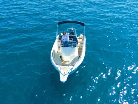 Two individuals enjoy a day on the water aboard a sleek boat, showcasing the perfect setting for a fun and relaxing boating experience.