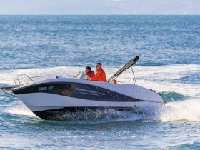 Two individuals enjoy a thrilling ride on a speedboat, cutting through the waves — a perfect snapshot of adventure on the water.
