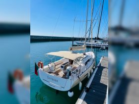 A beautiful view of the yacht 'Outsider' docked in calm waters, showcasing its sleek design and inviting atmosphere.
