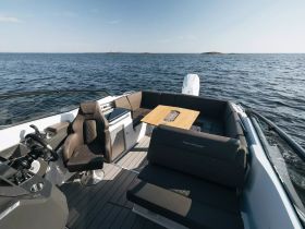 A stylish interior view of a boat's helm and seating area, showcasing modern design and comfort for a perfect day on the water.