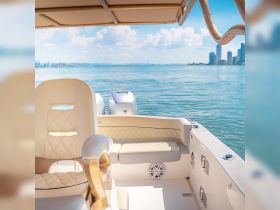 A beautifully designed helm area of a boat, showcasing luxurious seating and a stunning view of the water — perfect for a day out on the sea.