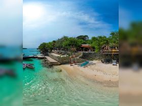 A picturesque beach scene featuring turquoise waters and a lively atmosphere, perfect for island adventures and relaxation.