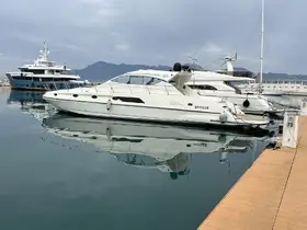A sleek yacht docked at a marina, showcasing its elegant design against a tranquil water backdrop — perfect for luxury boating experiences.