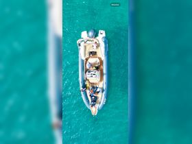 A lively group enjoys time aboard a boat in crystal-clear waters, perfect for fun-filled adventures on the water.