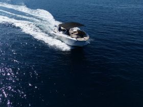 A sleek speedboat glides through deep blue waters, showcasing its elegant design and dynamic movement — perfect for thrilling adventures on the open sea.