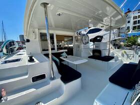 A spacious interior view of a yacht's cabin featuring comfortable seating and a well-equipped helm, perfect for relaxing or navigating on the water.