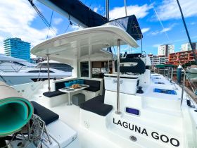 The interior of the 'Laguna Goo' catamaran features a spacious seating area, perfect for relaxing and enjoying the views while docked.