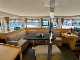 Interior view of a spacious boat cabin featuring comfortable seating and a helm area, perfect for relaxing and enjoying the journey on the water.