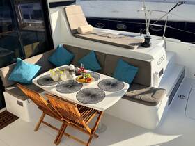 A beautifully arranged dining area on a yacht featuring comfortable seating and refreshing cocktails, perfect for enjoying meals while cruising.