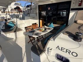 Interior view of the dining area on a yacht, featuring comfortable seating and a beautifully set table, perfect for enjoying meals while on the water.