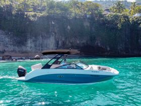 A sleek speedboat glides through crystal-clear waters, showcasing its stylish design and perfect for thrilling water adventures.