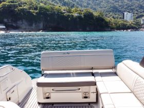 A well-appointed seating area on a Sea Ray boat, showcasing a comfortable space for relaxation while enjoying the scenic views of the coastline.