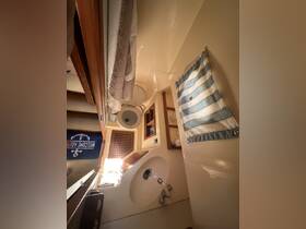 A well-lit view of the interior bathroom space on a boat, featuring modern amenities and a welcoming atmosphere.