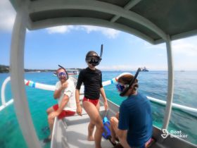 A group of snorkelers prepares for an underwater adventure aboard a boat, showcasing the excitement of ocean exploration.