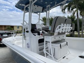Interior view of a well-equipped boat helm featuring comfortable seating and modern controls, ideal for a day on the water.