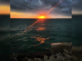 A stunning sunset over the ocean, casting vibrant reflections on the water — a perfect backdrop for evening boat trips and scenic views.