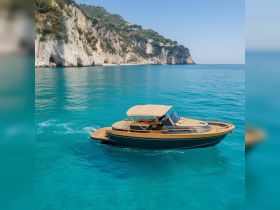 A sleek speedboat glides through crystal-clear turquoise waters, framed by stunning coastal cliffs — perfect for exploring beautiful destinations.