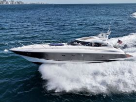 A stunning aerial view of a sleek yacht cruising through the waves, showcasing its elegant design and powerful performance on the water.