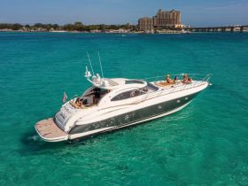 Aerial view of a luxurious yacht with a group enjoying their time on the water, showcasing the perfect setting for celebrations and gatherings.