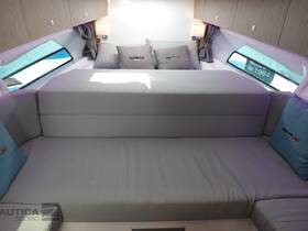 A cozy interior view of a boat cabin featuring comfortable seating and natural light streaming through the windows, perfect for relaxation on the water.