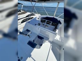 A well-equipped helm area featuring comfortable seating and navigation controls, perfect for steering your boat on the open water.