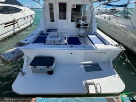 The interior of a boat featuring comfortable seating and a dining area, perfect for relaxing while enjoying the water.