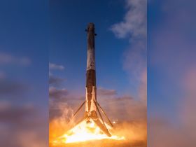 An image of a rocket launch, showcasing the powerful flames and smoke during liftoff. The scene captures the excitement of space exploration.