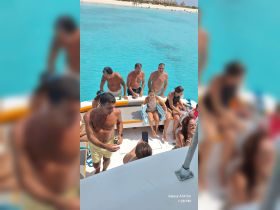 A lively group enjoys a fun day on the water, relaxing and socializing aboard a boat, perfect for summer outings and family adventures.