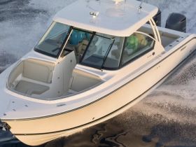 Aerial view of a sleek speedboat cruising through the water, showcasing its elegant design and performance capabilities.