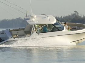 A group enjoys a thrilling ride on a sleek boat, showcasing the excitement of a day on the water.