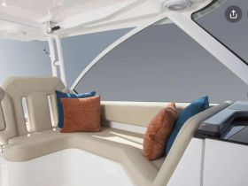 A stylish interior seating area on a boat, featuring comfortable cushions, perfect for relaxing while cruising on the water.