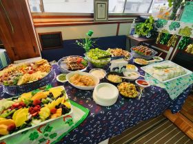 A beautifully arranged spread of delicious food and snacks onboard, perfect for catering events or gatherings on the water.