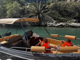 A family enjoys a sunny day on a boat, with children wearing life jackets, perfect for a fun and safe boating experience.