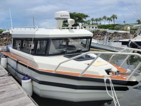 A detailed view of a boat docked at the marina, showcasing its sleek design and features, perfect for water adventures.