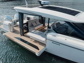 An aerial view of a sleek yacht showcasing its modern design and spacious deck, perfect for luxury outings on the water.