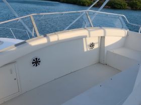 A clean and spacious interior view of a boat's helm area, showcasing comfortable seating and a well-designed layout for an enjoyable boating experience.