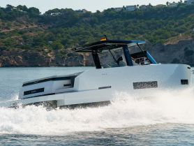 A sleek speedboat cuts through the water, showcasing its modern design and performance on a sunny day.